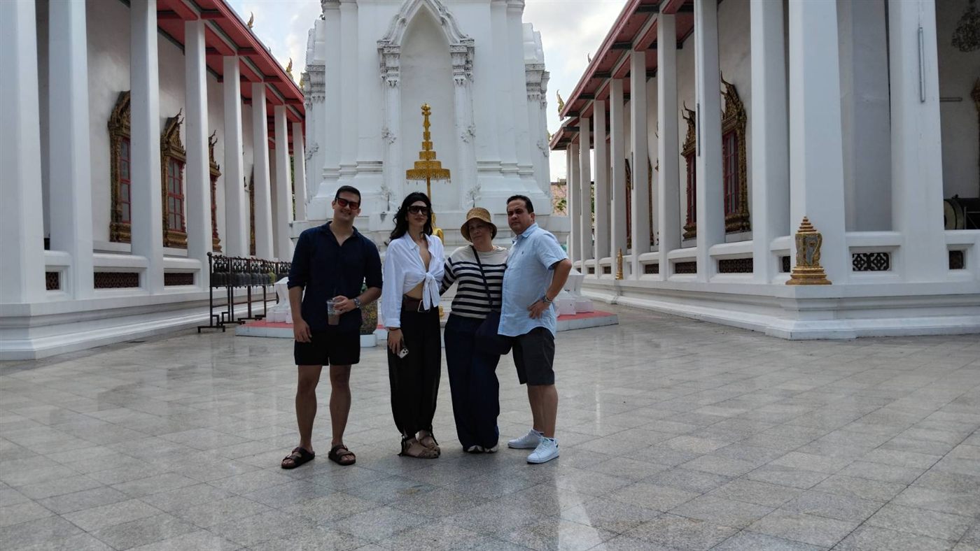 Family posing in a Thai temple courtyard